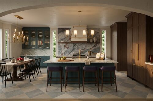 A spacious modern kitchen and dining area features a large central island with four dark upholstered stools, teal cabinetry, and a marble backsplash with veined stone. A wooden dining table, brass chandelier, and tall windows frame the room, while warm wood cabinetry and soft daylight create a refined, layered interior. Home Design, Rendering, Annilee Waterman, Dallas Texas